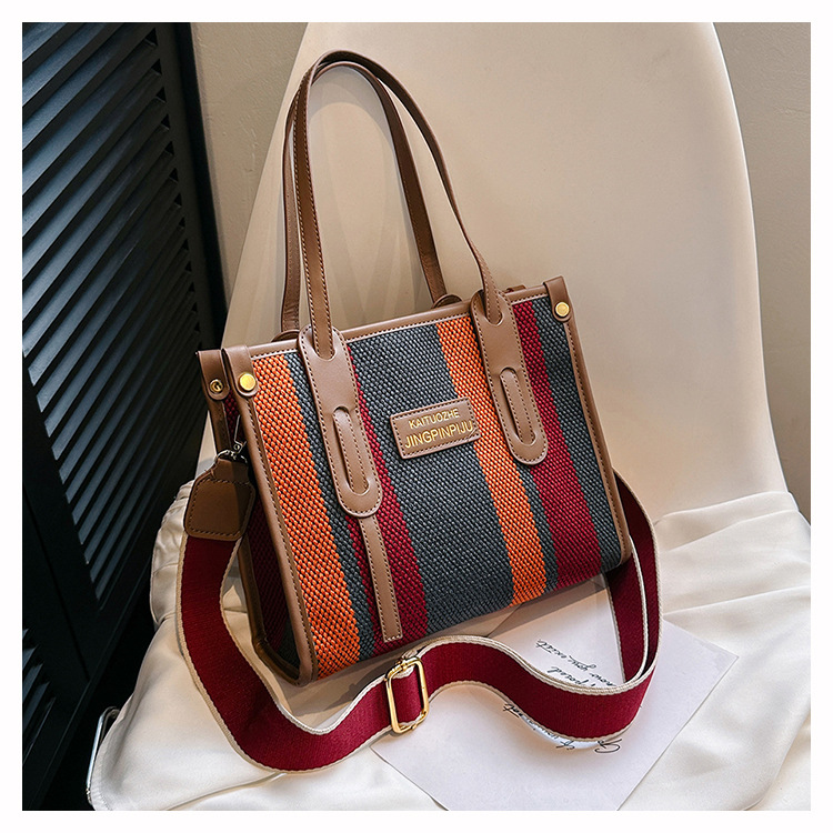 Bolso Tote portátil a rayas de color de contraste de lona para mujer 2024 nueva textura de moda transfronteriza bolso de mensajero de un solo hombro