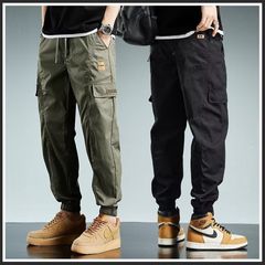 ズボンの男性の潮のブランドのごろつきのかっこいい仕事の服装のカジュアルなズボンの男性の秋の新型のかっこいい足首のズボンのポケットのゆったりしている9分のズボン