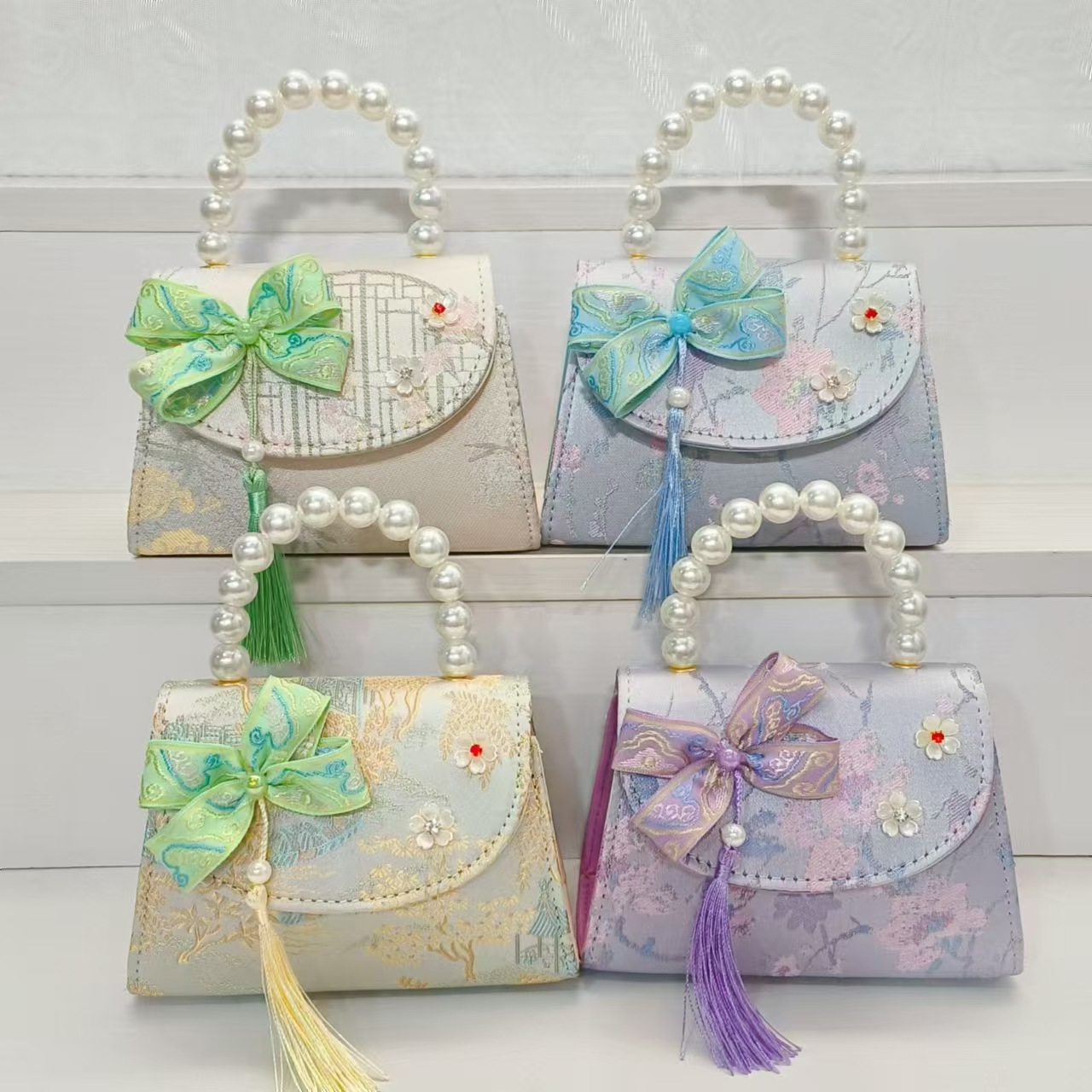 Bolsas de niños arco de estilo chino borda de niña pequeña princesa perla bolsa de cambio de mano al por mayor
