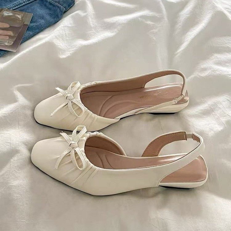 Explosiones de estilo francés con cabeza de media zapatillas para mujeres 2026 verano nuevo arco de tacón bajo sandalias de viento suaves para mujeres