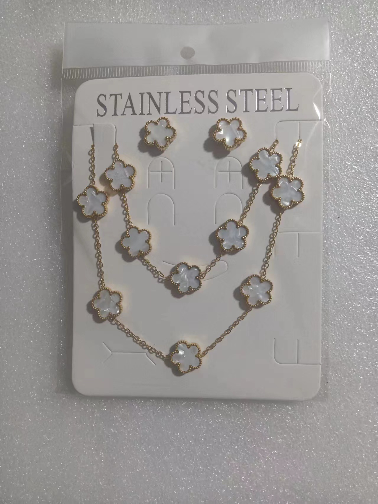 Trébol de cinco hojas de la suerte nuevo estilo transfronterizo pulsera de acero de titanio de doble cara, collar, aretes, moda de nicho de 18K, no se desvanece