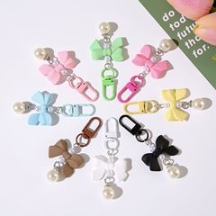 新しい蝶結びの手の感応の漆の樹脂のペンダントの携帯電話のアクセサリのイヤホンのカバンのアクセサリーのアパレルの学生の贈り物