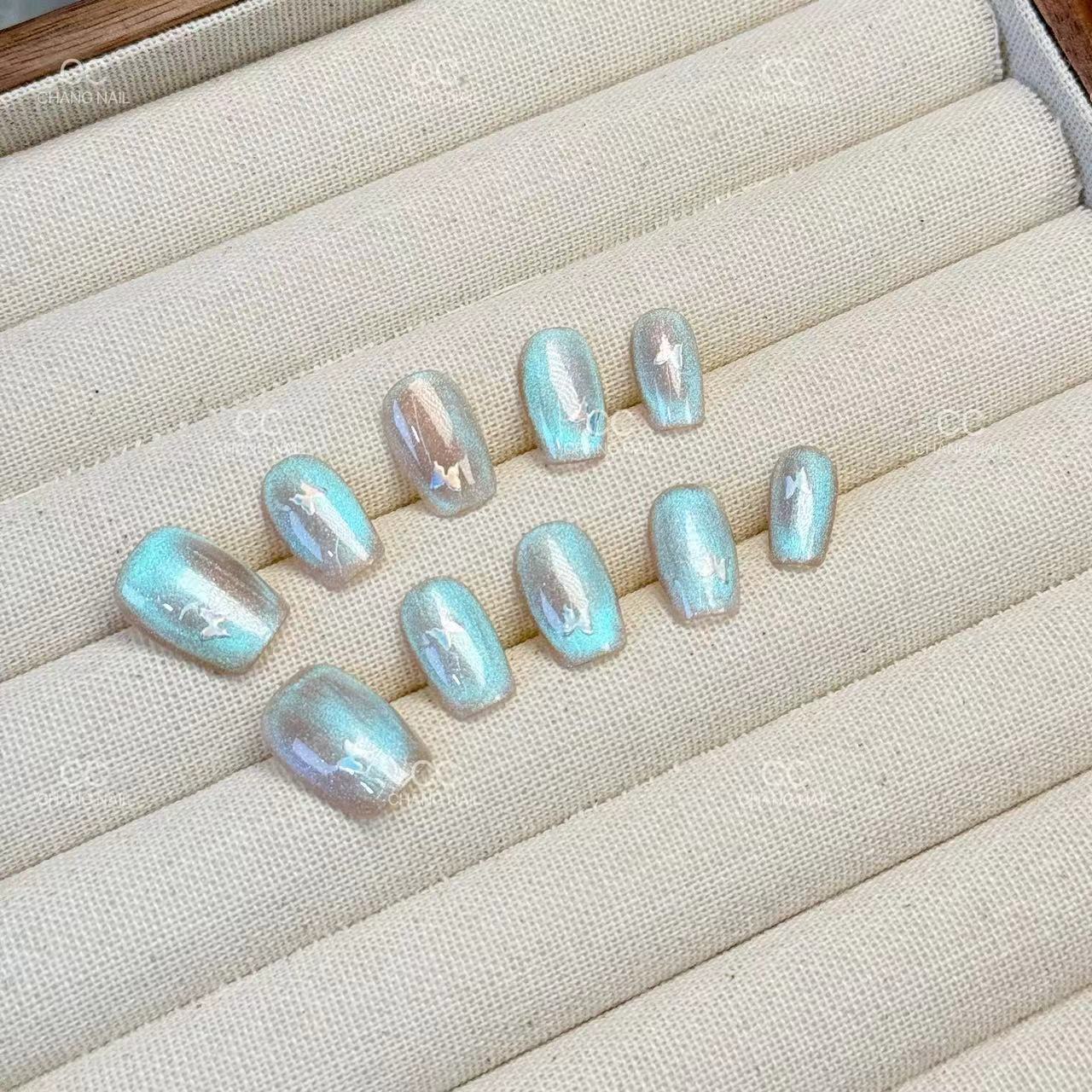 [Perlas] El ojo de gato está hecho a mano, el temperamento de la uña es suave y blanco, y el parche de manicura de fototerapia con diamantes está terminado.