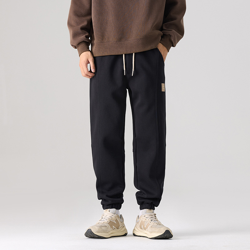Mick Jones2025 caño hombre pantalones casuales holgados versátiles estilo coreano pantalones deportivos largos negros regulares