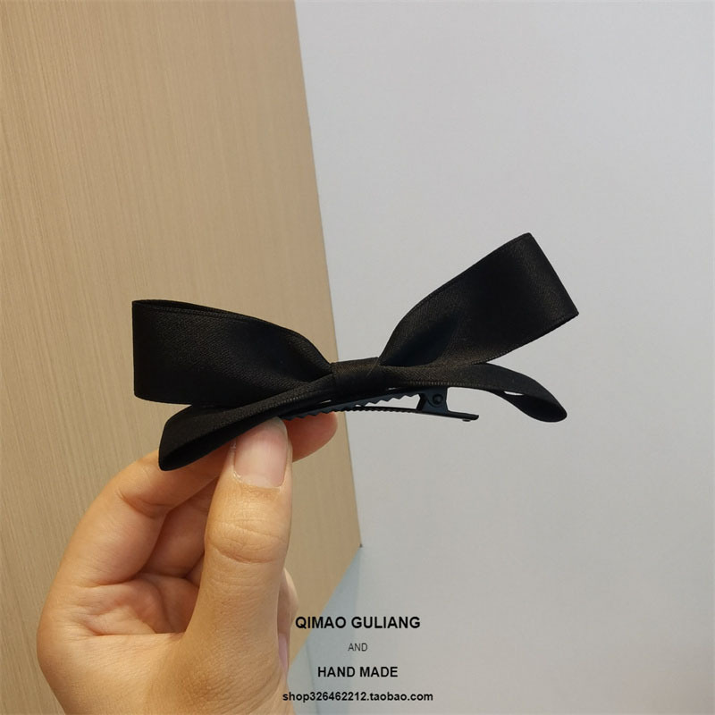 Black three-dimensional bow
