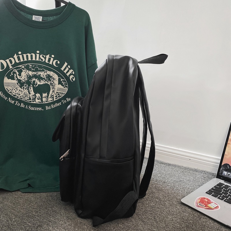 Comercio exterior al por mayor 2023 nueva versión coreana de la mochila de cuero suave para estudiantes de secundaria Mochila de computadora de gran capacidad de color sólido de moda