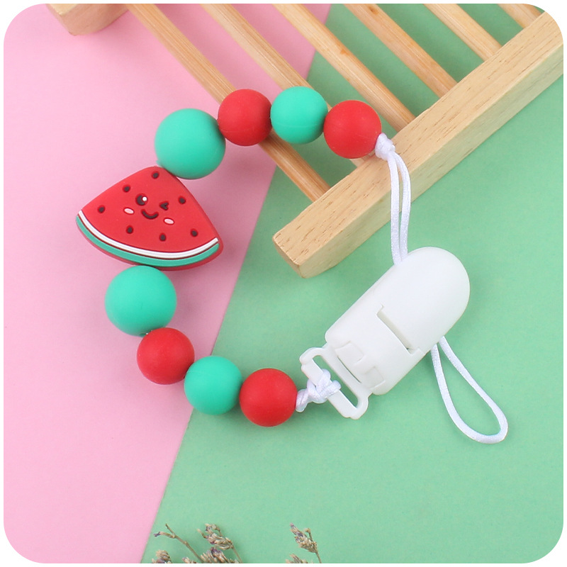 Suministros para bebés de dibujos animados fruta chupete cadena calmante bebé de silicona sandía mordedura molar anti-gota cadena Nuevo