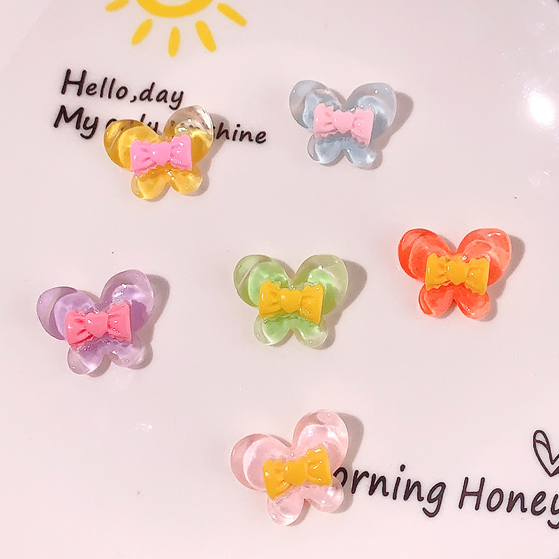 Nuevo color transparente mariposa arco DIY accesorios de resina pegamento crema caja de teléfono móvil adornamiento de pelo agujero material de parche de zapatos agujero