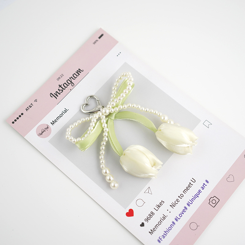Venta caliente todo fósforo tulipán perla rosa serpentina arco púrpura colgante amor llavero bolso colgante