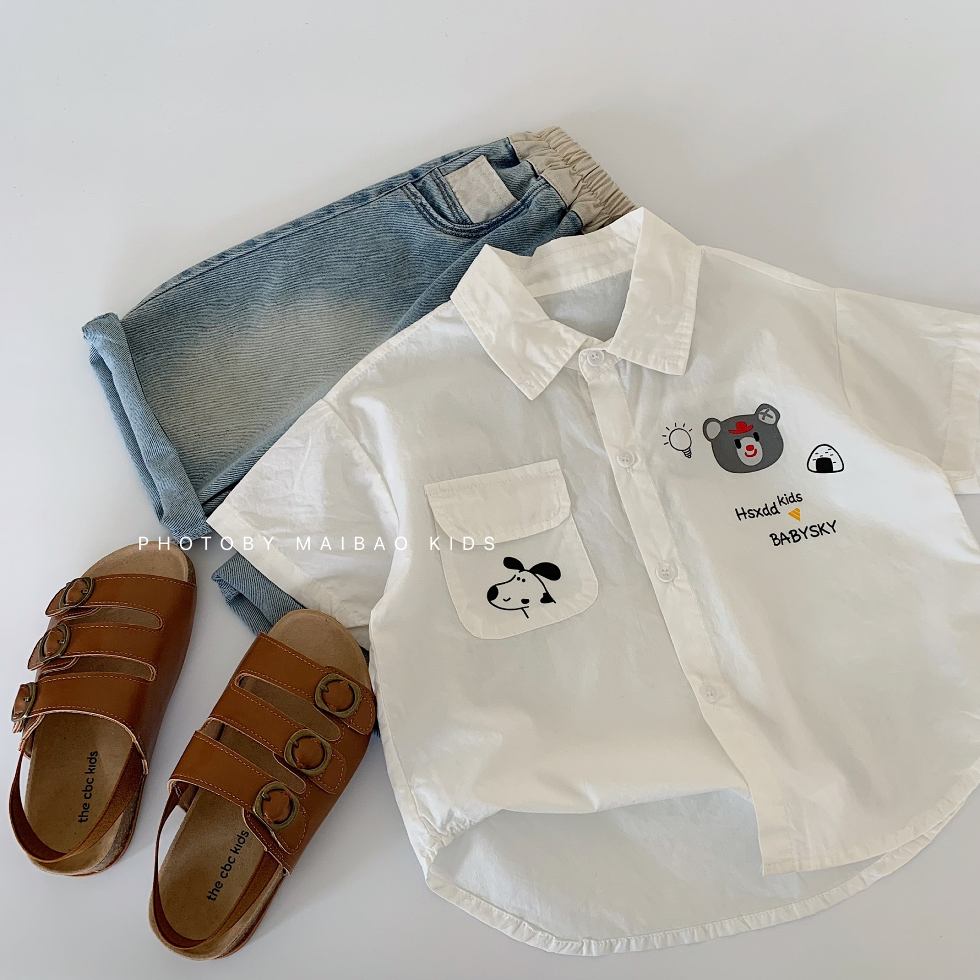 Camisa para niños Maibao 2025 verano nuevo estilo coreano niños y niñas dibujos animados camisa de manga corta ropa de verano para bebés al por mayor