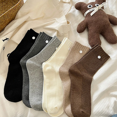 Cream-colored sock with retro style vertical stripes, solid color abalone buttons, crew length sock, autumn and winter Marmite style, puffy sock