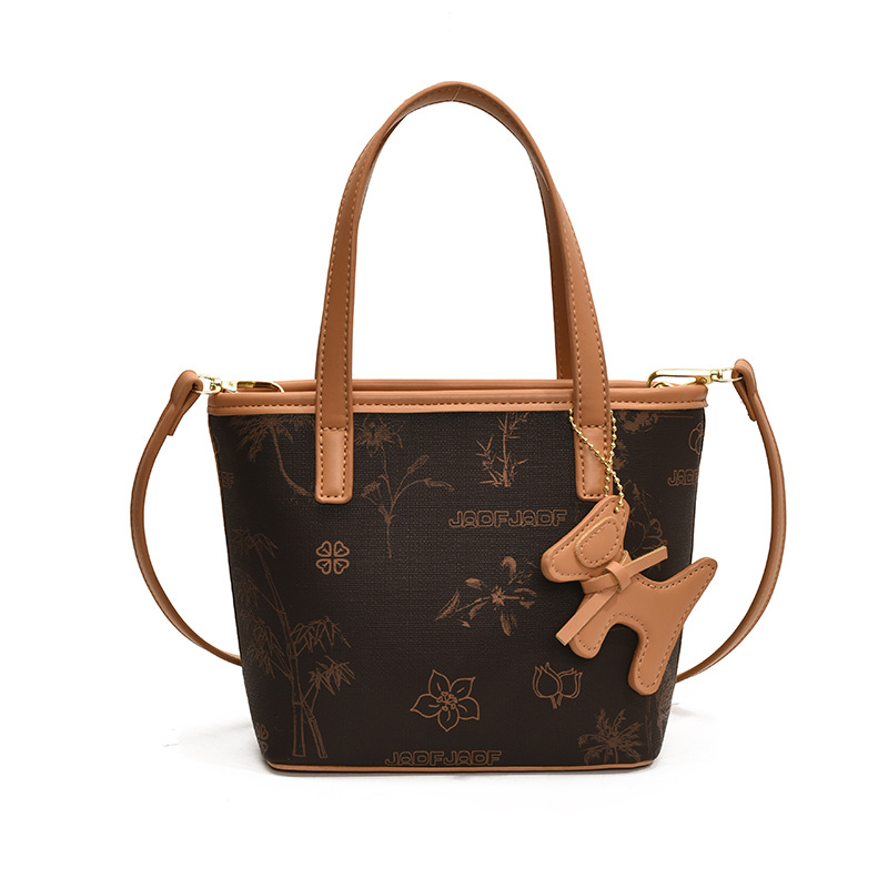 Bolso de mano caliente de tendencia universal para mujeres 2025 nuevo popular bolso de hombro explosivo sensación alta bolso de cubo coreano