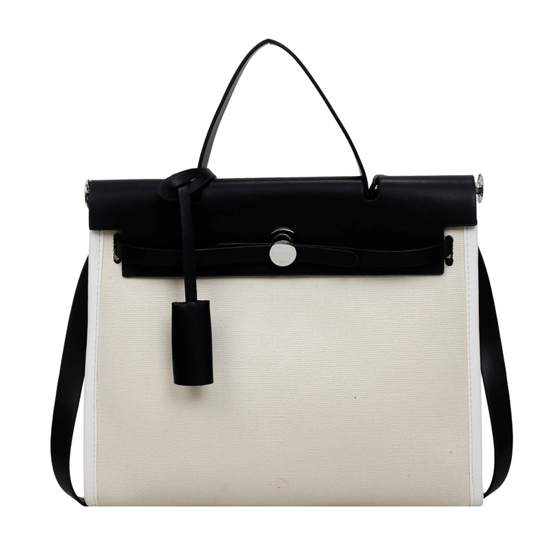 Nicho de moda portátil Kelly bolso mujer 2026 nuevo cross-border lienzo empalme color contraste viaje mochila de hombro