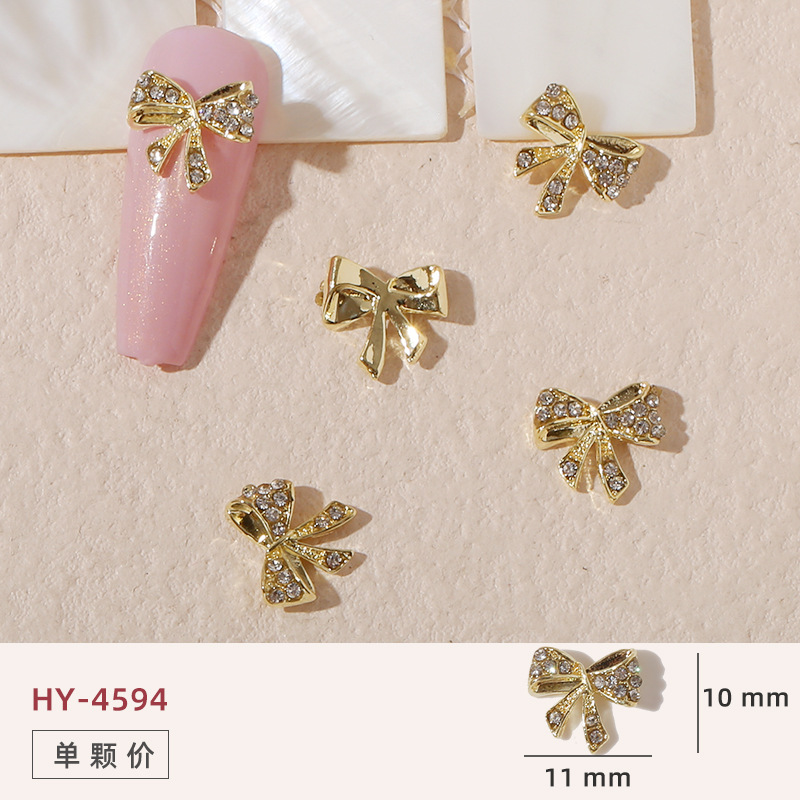 Uñas mariposa joyería nueva línea popular perla arco metal decoración de uñas pequeños accesorios de joyería al por mayor