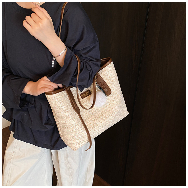 This is a new 2025 summer beach-style women's bag with a simple and versatile hand-held design. It's a single-shoulder vacation woven bag undefined