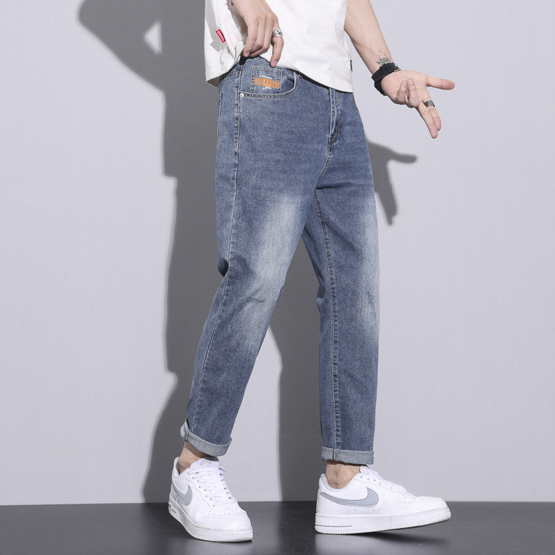 Pantalones vaqueros blancos lavados vintage de la estación europea de los hombres nuevos pantalones largos de los hombres elásticos flojos de moda del todo-fósforo