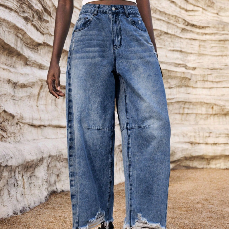 Light blue washed high-waisted split-leg lantern-style cropped jeans with large ripped hems, frayed edges, side pockets, and small holes, loose fit