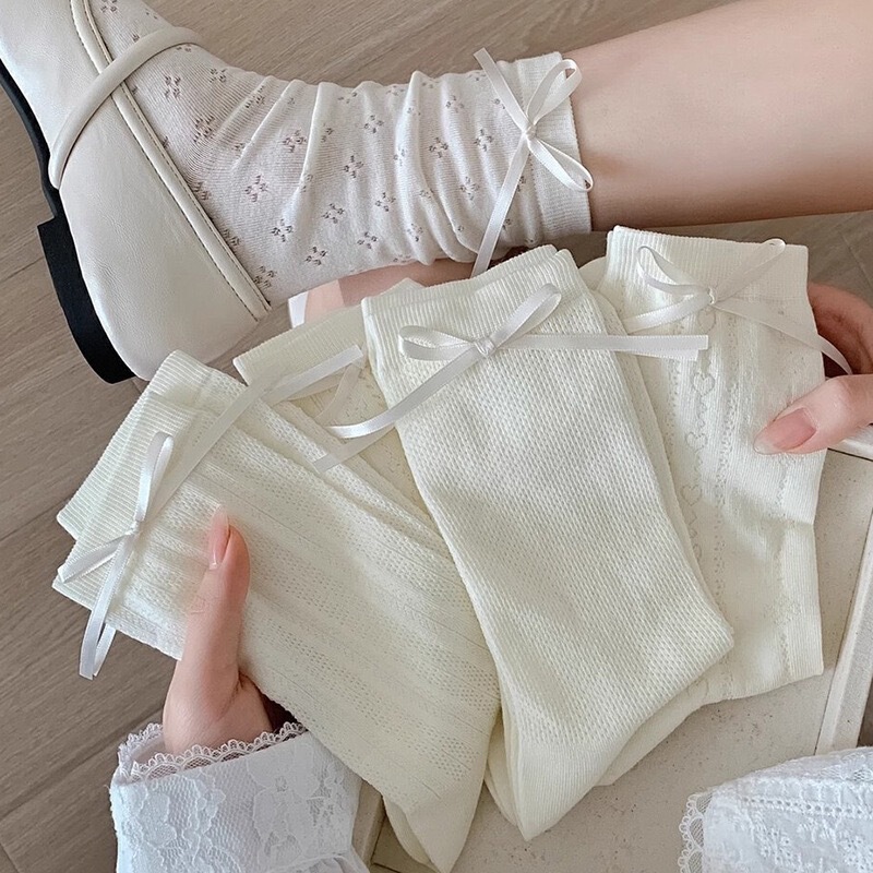 Ins-style Korean white bow-tie socks, featuring a delicate, hollowed-out floral design, creating a gentle and youthful look, mid-calf length, and a trendy, ruffled style for women