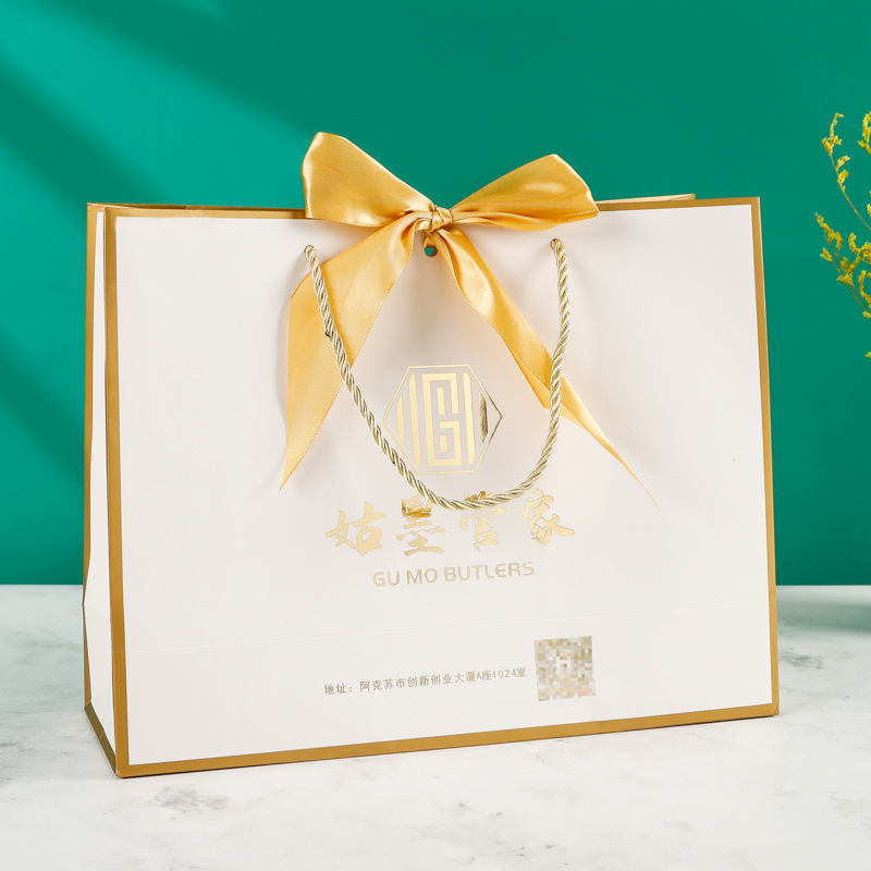 Fábrica al por mayor arco bolsa de papel portátil ropa bolsa de embalaje bolso de cartón blanco con logotipo impreso