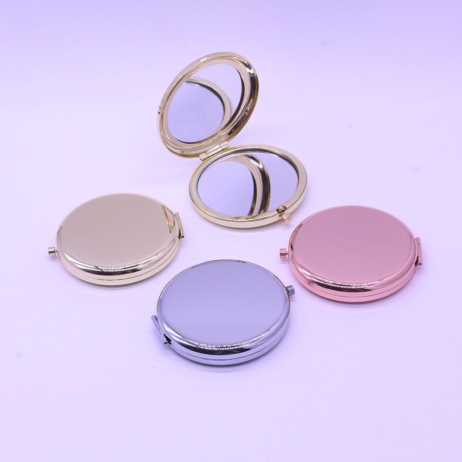 El espejo pequeño de doble luz plegable de metal de alta gama se puede grabar con el logotipo y el espejo de maquillaje portátil de mano al por mayor