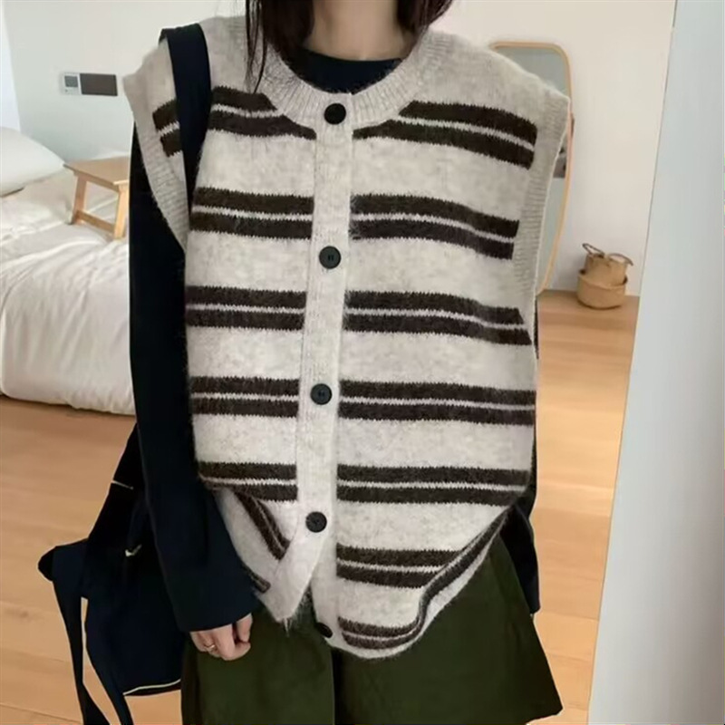 Korean-style, relaxed-fit, oversized striped knit vest for women, featuring a round neckline, button closure, and designed for layering as a cardigan or standalone top Korean-style, relaxed-fit, oversized striped knit vest for women, featuring a round neckline, button closure, and designed for layering as a cardigan or standalone top