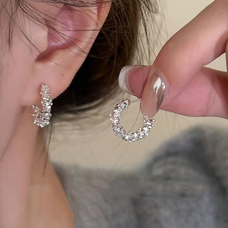 Un par de clavos en las orejas con plata rota
