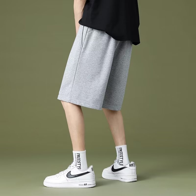 Pantalonos de cinco puntos de color sólido para parejas de moda masculinas delgados cintura elástica de verano universal simple adelgazamiento deportivo ocio