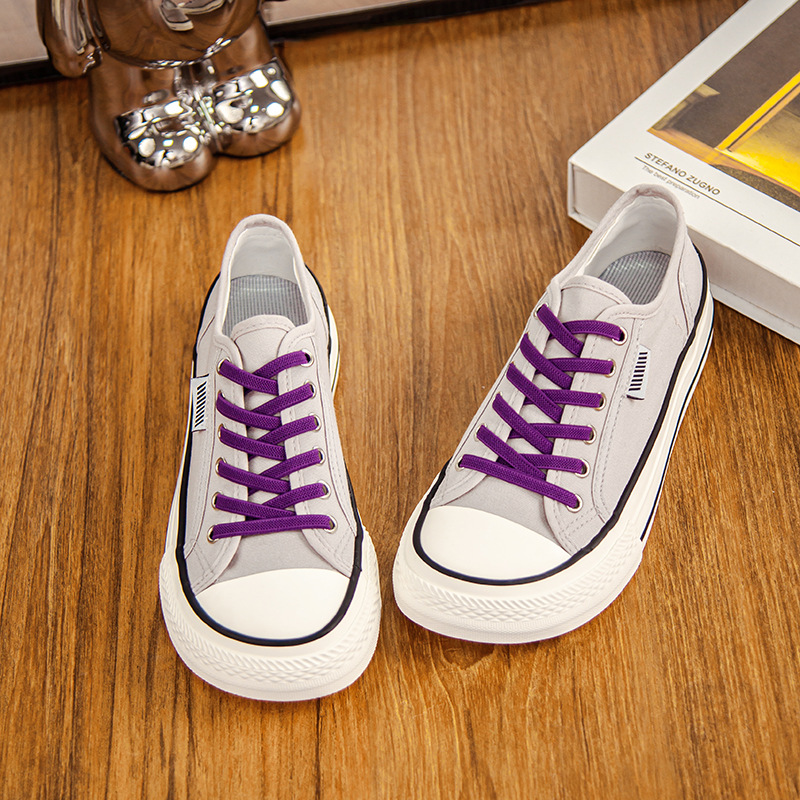 2026 primavera y verano nuevos zapatos de lona de mujer de altura baja con suela gruesa delantera correa de abertura superficial zapatos de lona casuales de estudiantes