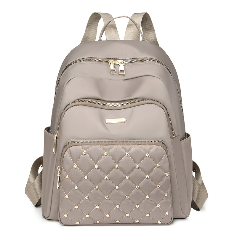 Comercio exterior al por mayor 2024 nuevo estilo casual señoras Lingge mochila moda remache color contraste mochila ligera mochila escolar marea