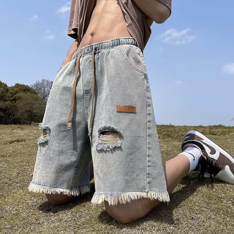 Pantalones cortos de mezclilla rasgados con bordes sin rebabas para hombre American High Street retro verano delgado casual tendencia guapos pantalones de cinco puntos