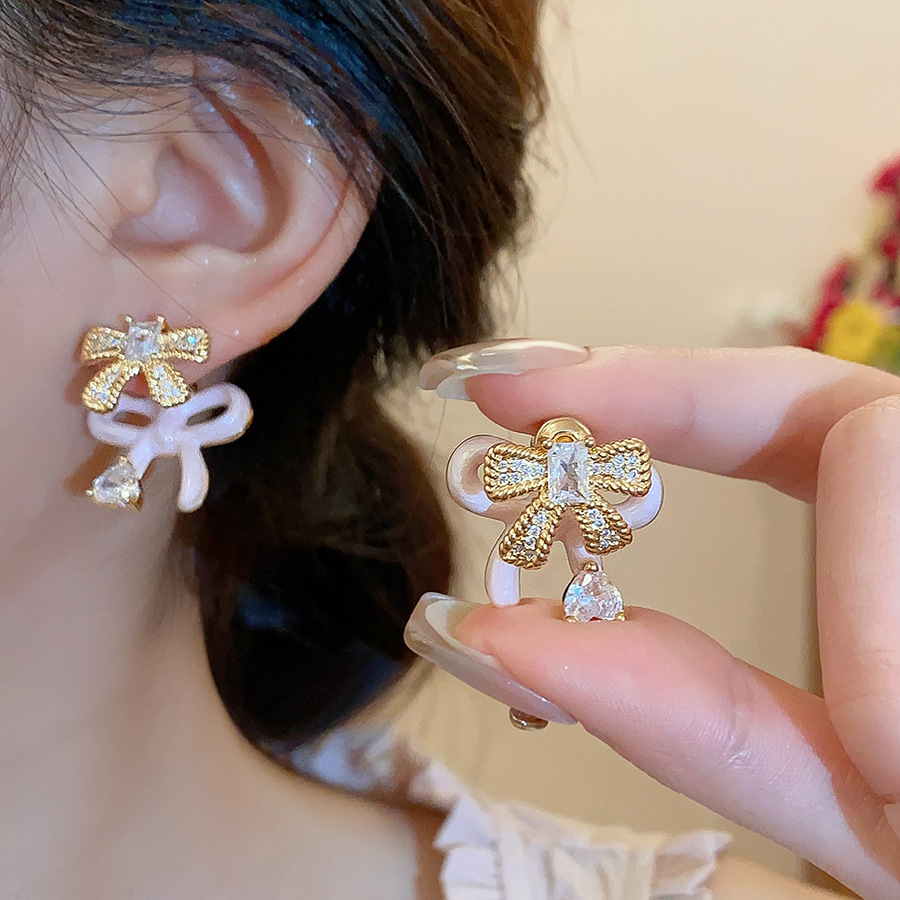 Pendientes de flor de lazo elegante de súper hada de plata Pendientes de moda de lujo ligero francés Pendientes de todo fósforo dulce de estilo literario