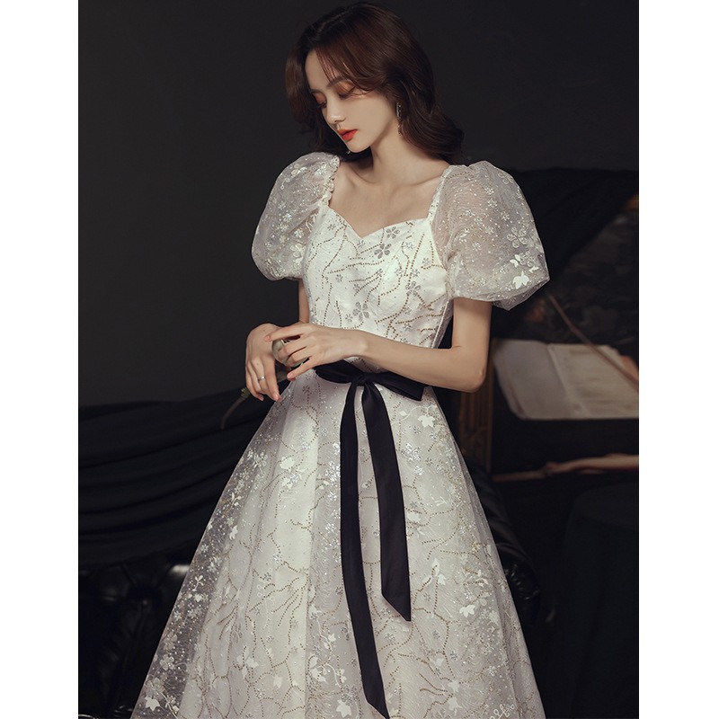 Vestido de noche para banquete, nuevo estilo 2026, blanco, estilo francés, elegante, de hada, largo, con falda abullonada, para fiesta anual.