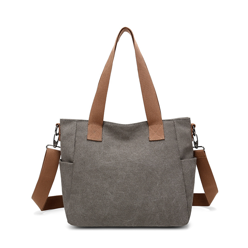 2025 bolsas de mujer europeas y estadounidenses transfronterizas nuevas bolsas de viaje de gran capacidad bolsas de hombro de lona de color sólido bolsas de brazo