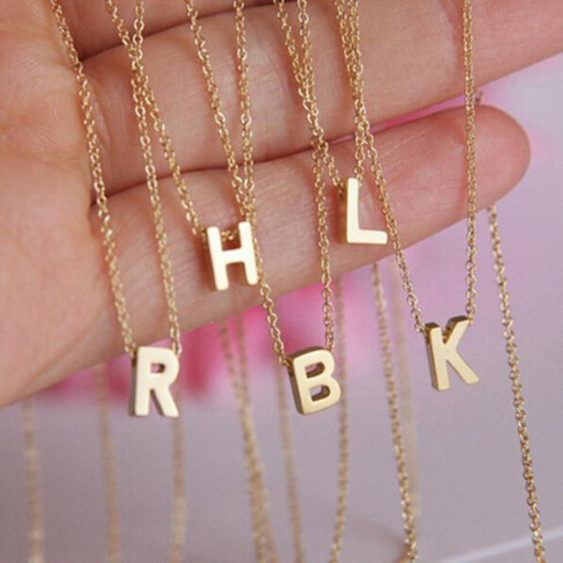 brand golden necklace with letters