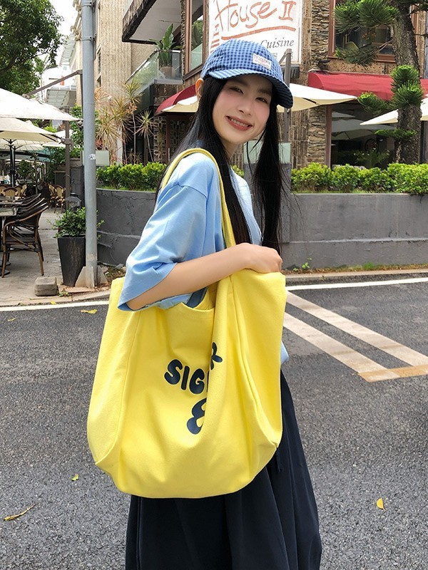 純色の怠惰な風のショルダーバッグは女性2025夏の新型の大容量のキャンバスの特包の潮のアルファベットのショッピングバッグを包みます。|undefined