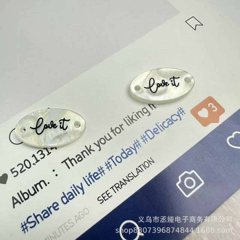 现货仿贝树脂商标吊牌字母椭圆蝴蝶结衣标高端百搭装饰纽扣60款|undefined
