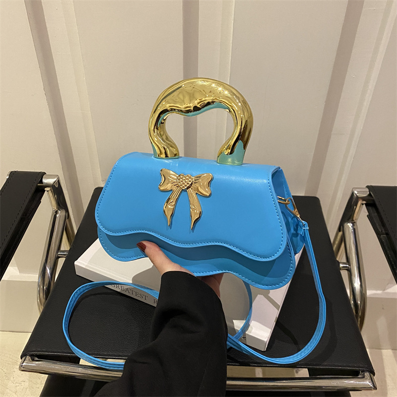 Bolso de arco ondulado damas 2024 nuevo otoño invierno bolso de hombro color caramelo estilo extranjero bolso de mochila elegante