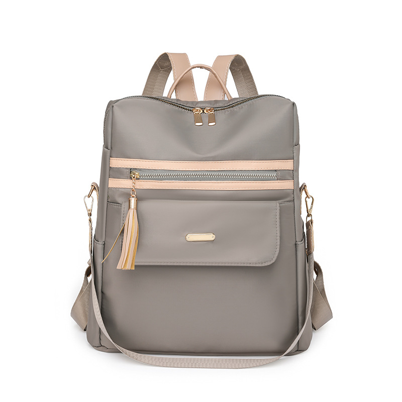 2023 nueva mochila casual para mujer nylon color contraste moda borla mochila de viaje multifuncional de doble uso al por mayor