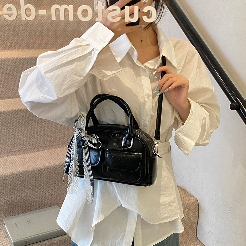 Bolso de Boston portátil casual transfronterizo para mujer 2025 nuevo bolso de mensajero de hombro con lazo simple y versátil coreano