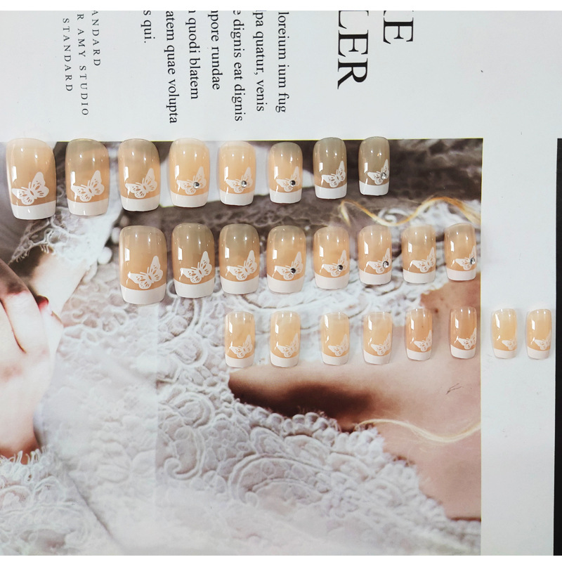 Polvo desnudo punto de perforación mariposa para usar uñas de borde blanco largo estilo francés fresco y elegante 24 piezas de parche de uñas terminadas