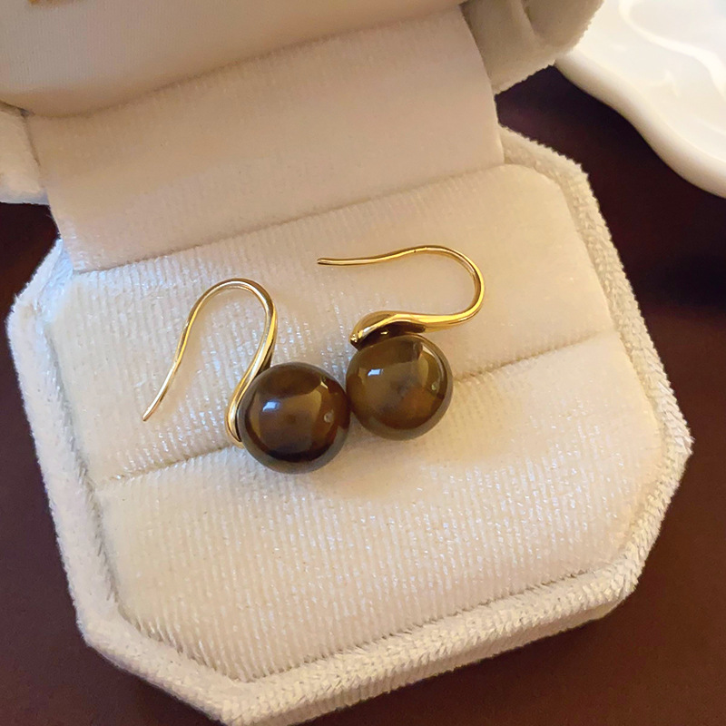 Pendientes de ojo de tigre artificial de color café Maillard con aguja de plata Pendientes simples y de moda de todo fósforo Pendientes ligeros de lujo de alta gama