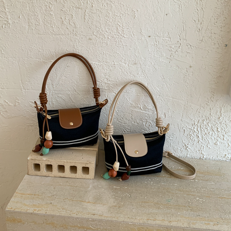 La versión coreana de nicho de diseño minimalista bolso de brazo para mujeres verano 2026 nuevo estilo extranjero versátil bolso de mochila casual diario