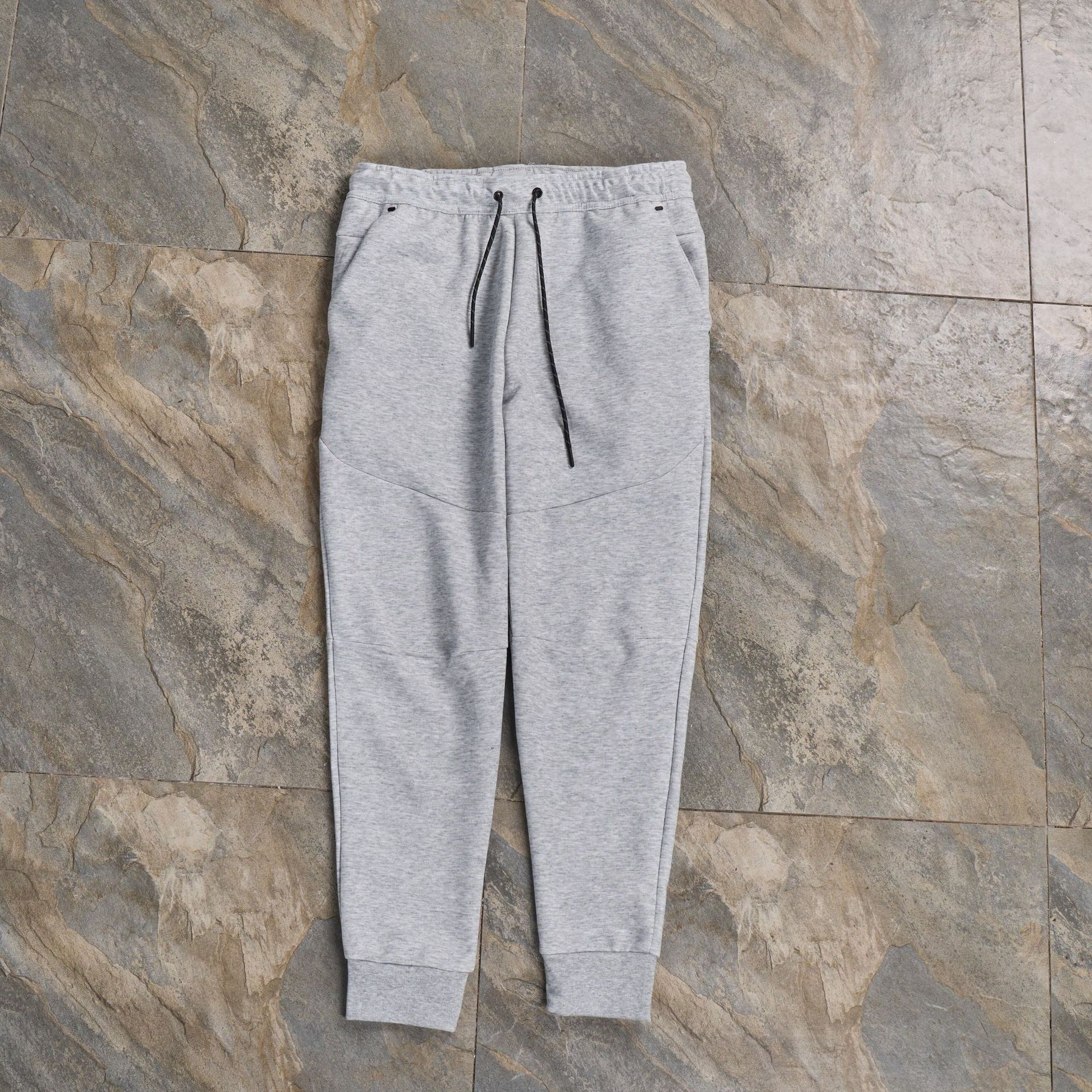 Pantalones casuales deportivos primavera y otoño aire laminado de algodón con cremallera pantalones deportivos para hombres y mujeres