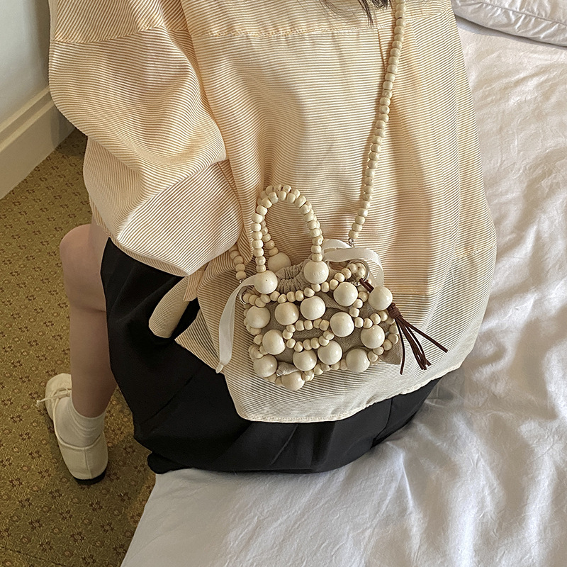 Nuevo bolso chino para niños con cuentas extranjeras, mini mochila para niños, bolsa de hombro de bebé tejida hueca