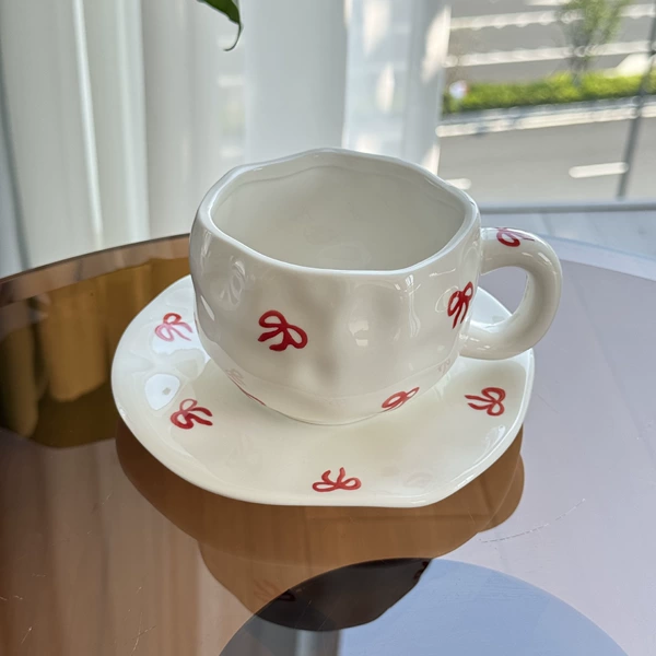 Single bow underglaze colored cup and plate