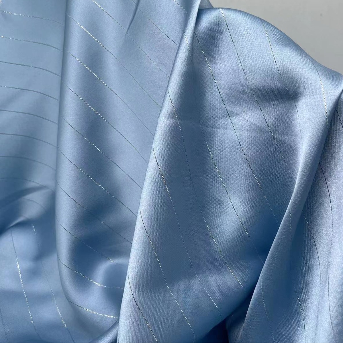 Silver-acetate-like silk-striped fabric, polyester-spandex fashion fabric for trendy Hanfu-style dresses—wholesale available for spring and summer collections.