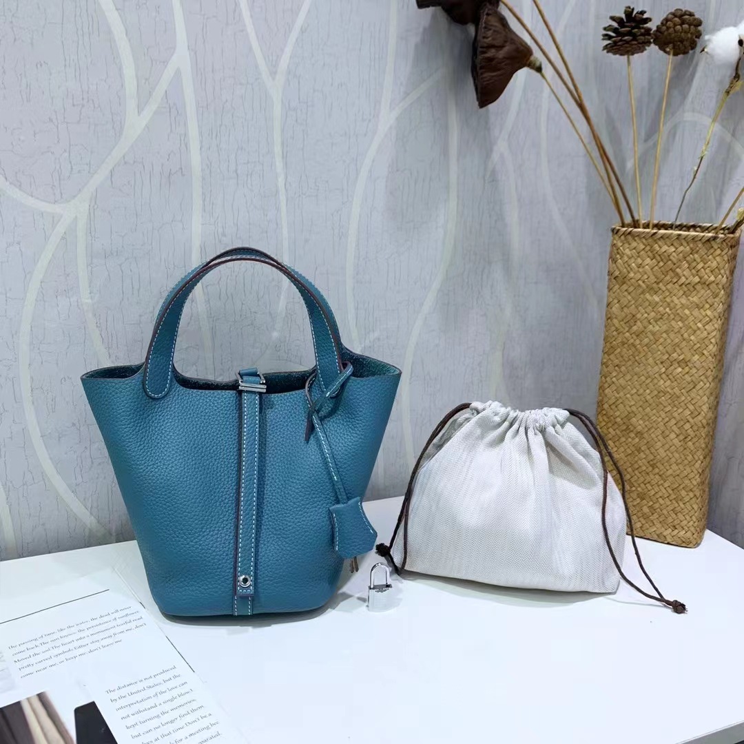 El nuevo bolso de cesta de verduras de marea de cuero togo de piel de vaca de capa superior 2025, bolso de cubo con cerradura de mano, bolso de cuero para mujer