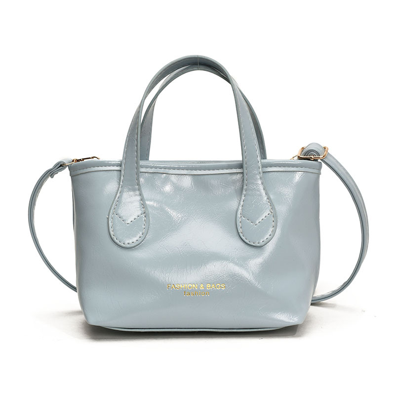 Bolso de cubo de textura de color sólido para mujer 2025 primavera nueva moda bolso de mensajero coreano estilo occidental de alta gama para mujer