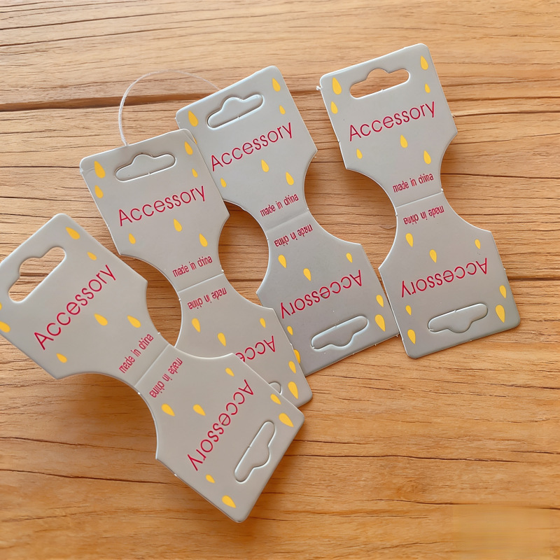 Tarjeta de embalaje de tarjeta plegable especial creativa tarjeta de cuerda de cabello infantil tarjeta de papel de anillo de intestino grueso tarjeta de cabeza de cuerda de papel joyas tarjeta de visualización
