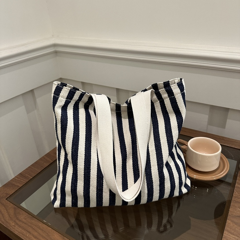 The new cross-border vertical striped commuter tote bag, hand-held shoulder bag, is fashionable and has a large capacity. It features an InS-style simple letter sail undefined